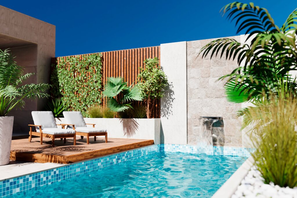 Modern backyard with a swimming pool, wooden deck, two lounge chairs, green plants, and a stone wall fountain under a clear blue sky.
